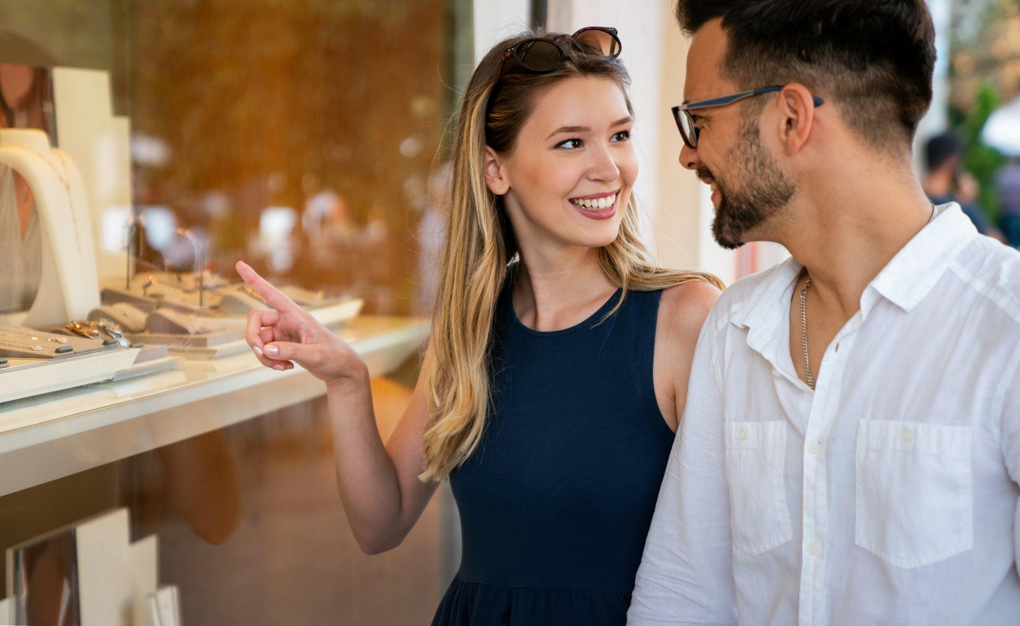 Beautiful young couple enjoying in shopping, having fun in the city. Love, dating, lifestyle concept